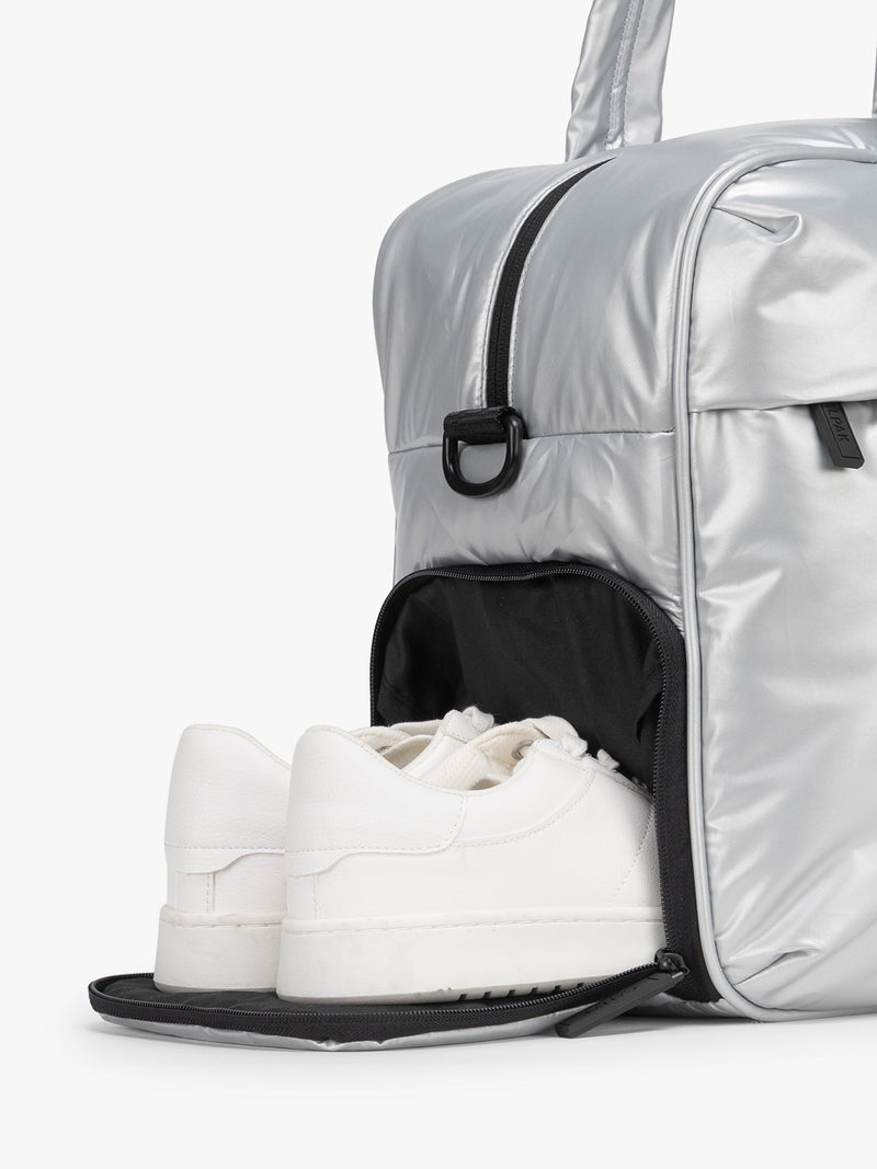 CALPAK Silver Luka Duffel side shoe compartment a white background