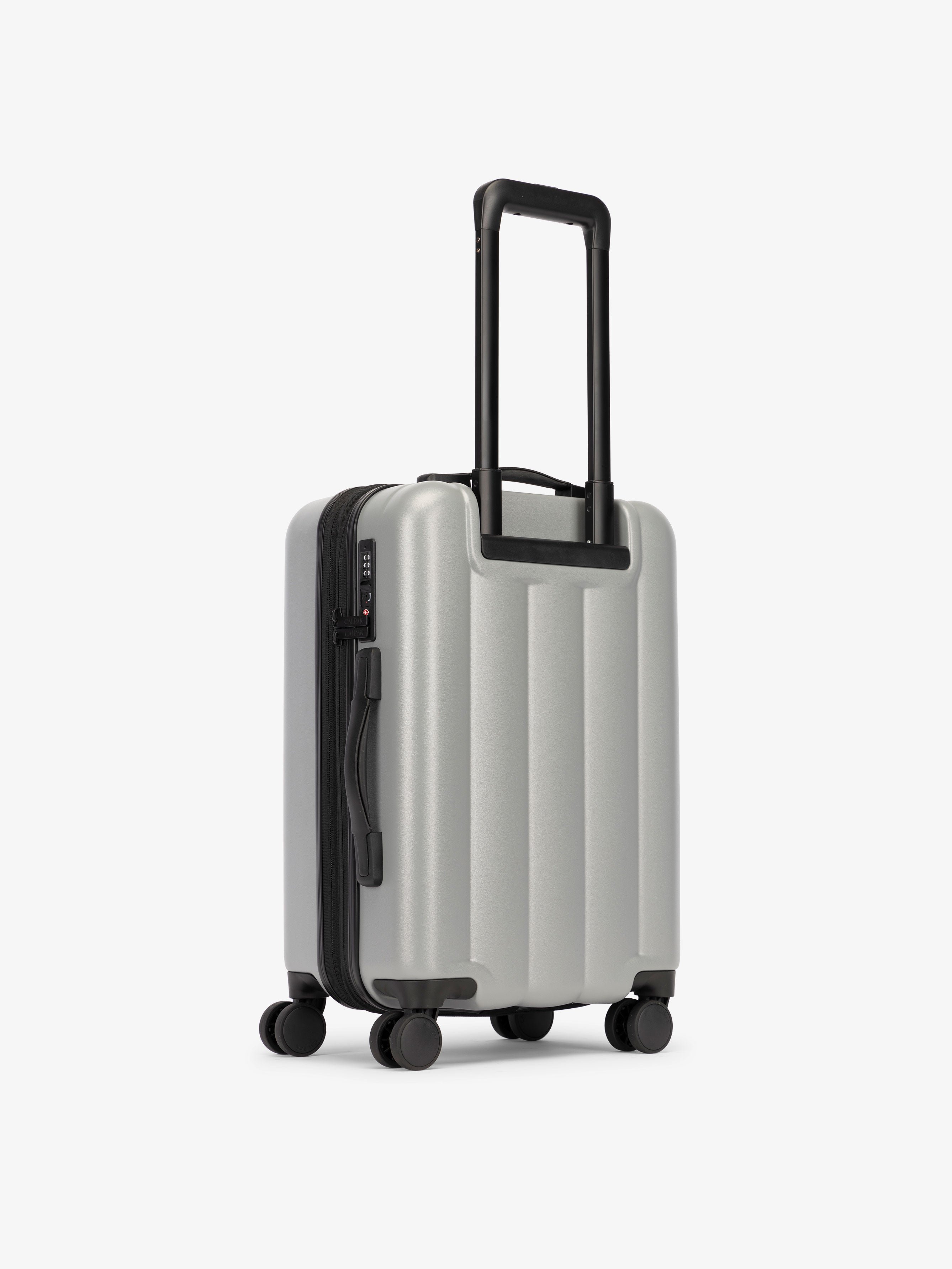 CALPAK carry-on luggage featuring dual spinner wheels and bottom grab handle in smoke