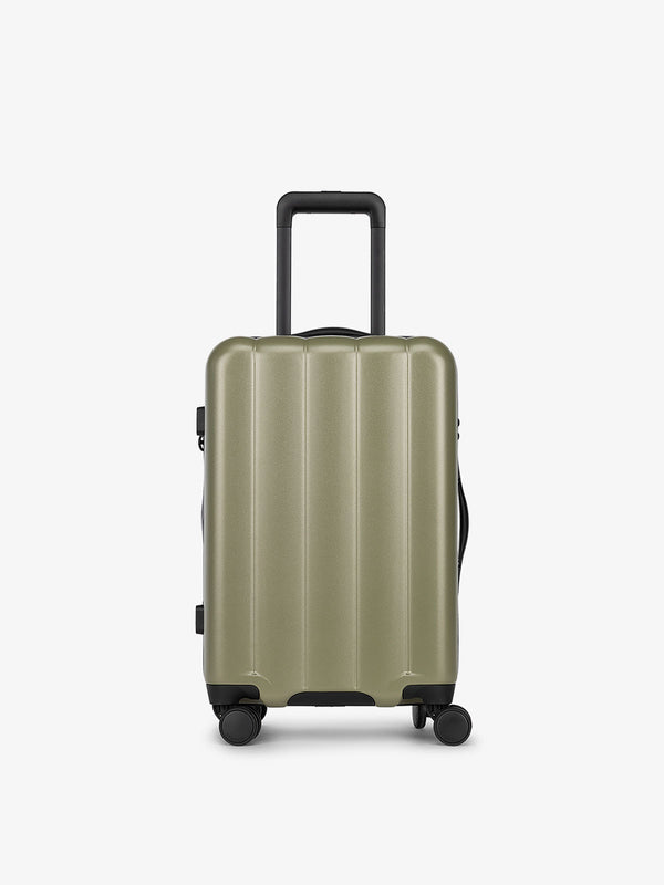 Pistachio green CALPAK carry-on luggage made from an ultra-durable polycarbonate shell and expandable by up to 2"