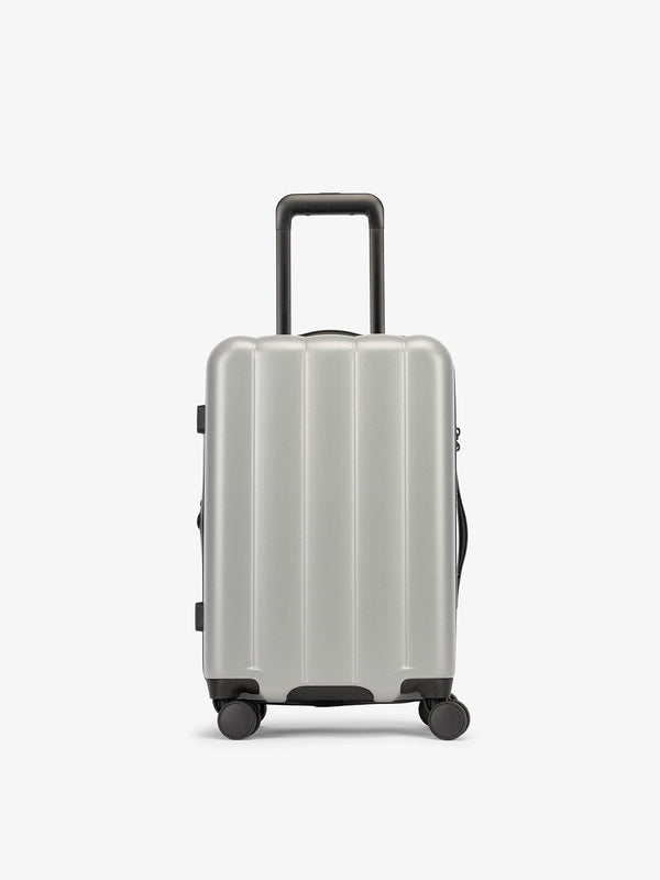 CALPAK Smoke gray carry-on luggage made from an ultra-durable polycarbonate shell and expandable by up to 2"