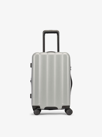CALPAK Smoke gray carry-on luggage made from an ultra-durable polycarbonate shell and expandable by up to 2