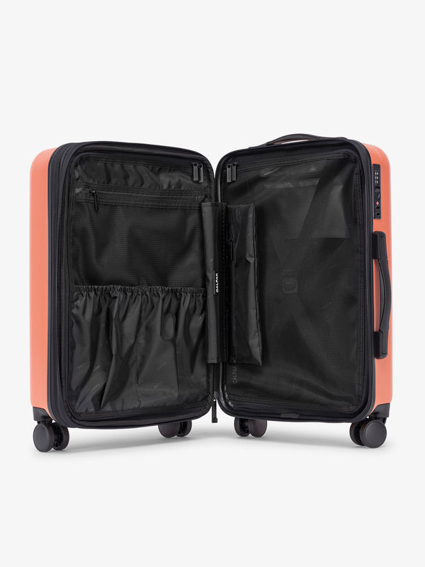 Orange persimmon CALPAK Evry Carry-On Luggage features divided compartments with interior pockets for organized packing
