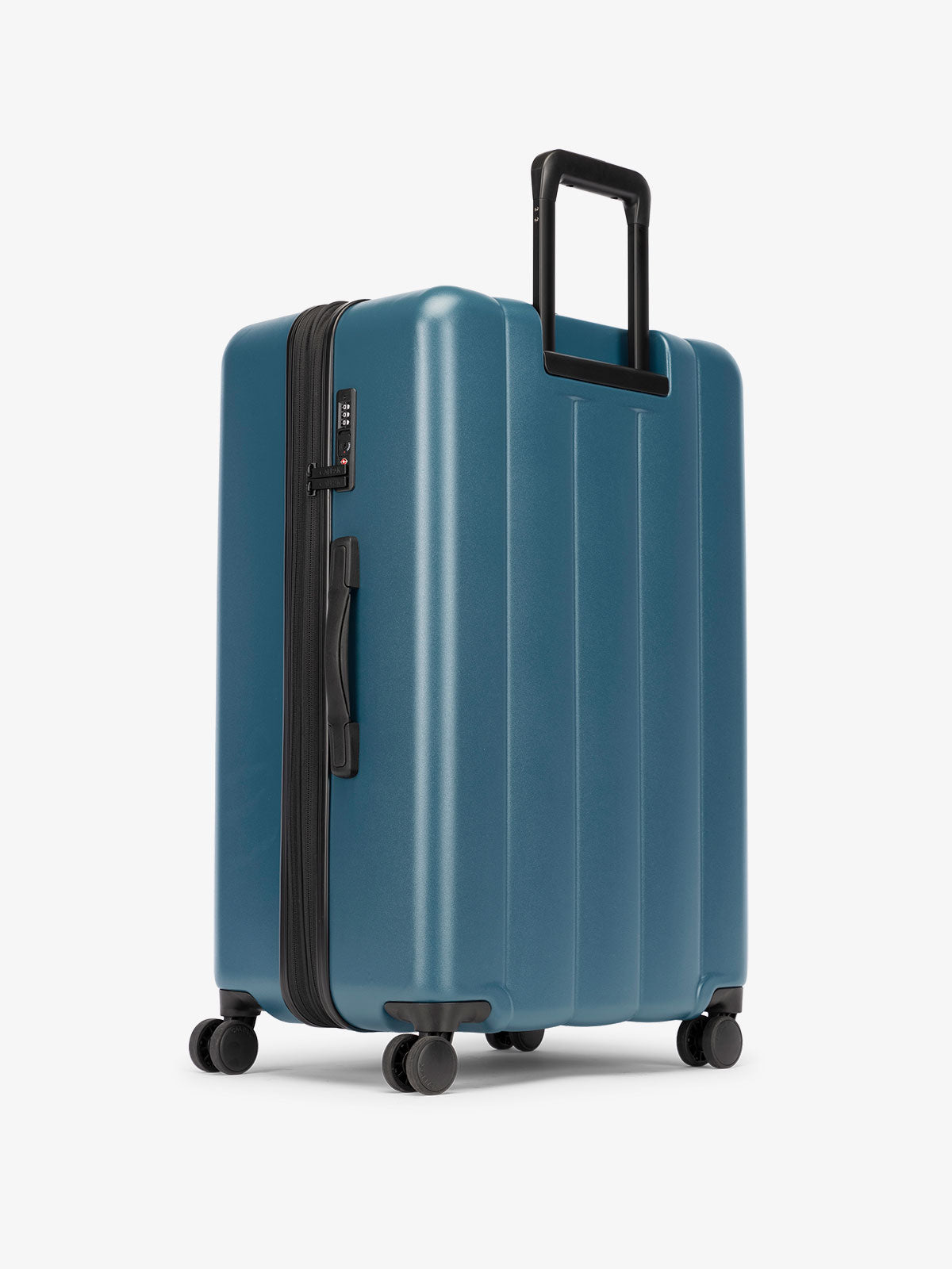 CALPAK large luggage featuring dual spinner wheels and bottom grab handle in blue; LCO1028-PACIFIC