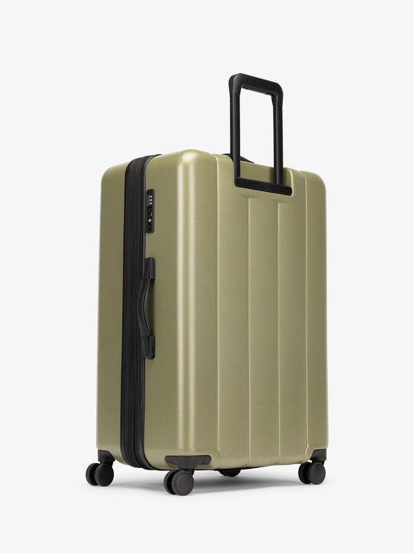 CALPAK large luggage featuring dual spinner wheels and bottom grab handle in pistachio green
