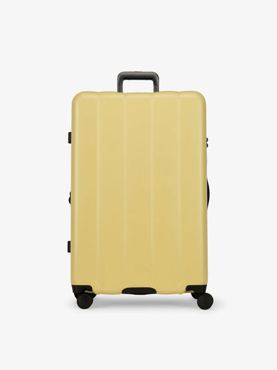 CALPAK yellow butter large luggage made from an ultra-durable polycarbonate shell and expandable by up to 2; LCO1028-BUTTER view 1