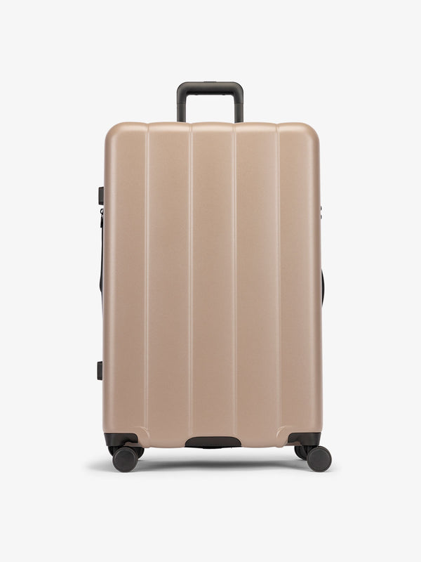 Brown chocolate large luggage made from an ultra-durable polycarbonate shell and expandable by up to 2"