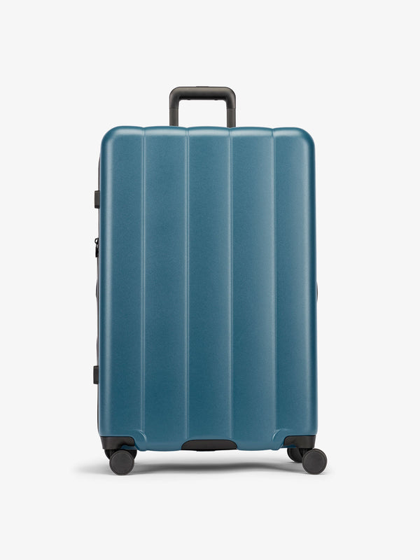 CALPAK Pacific blue large luggage made from an ultra-durable polycarbonate shell and expandable by up to 2"
