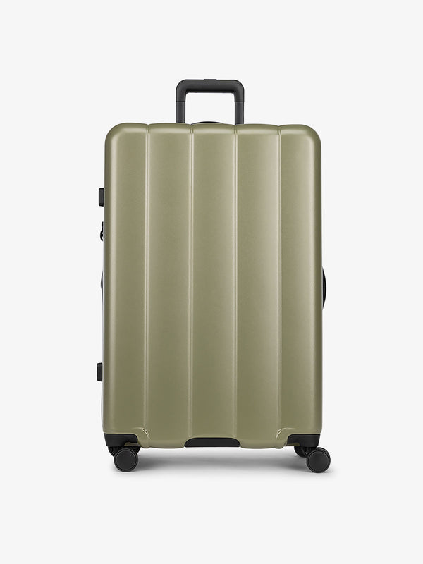 CALPAK Pistachio green large luggage made from an ultra-durable polycarbonate shell and expandable by up to 2"