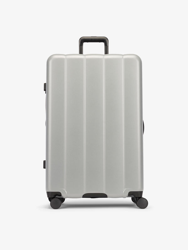 CALPAK Gray smoke large luggage made from an ultra-durable polycarbonate shell and expandable by up to 2"