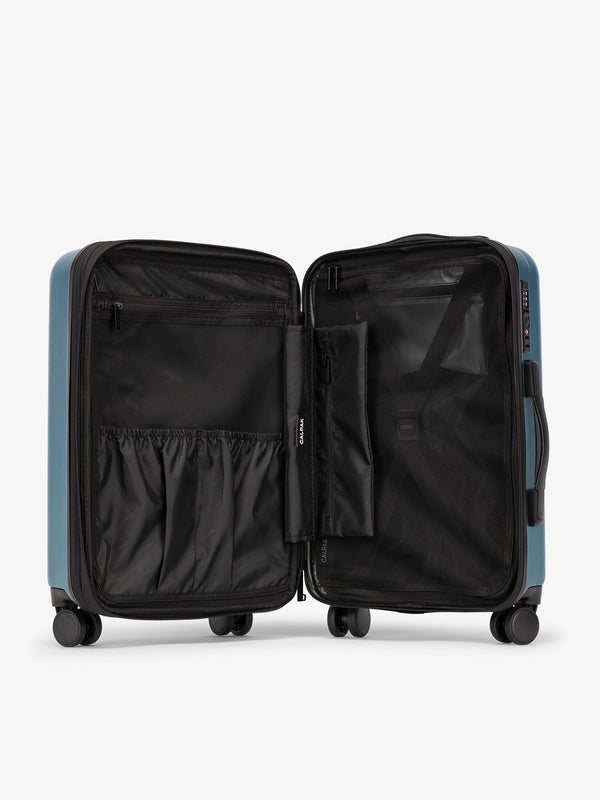 Pacific blue CALPAK Evry Large Luggage features divided compartments with interior pockets for organized packing