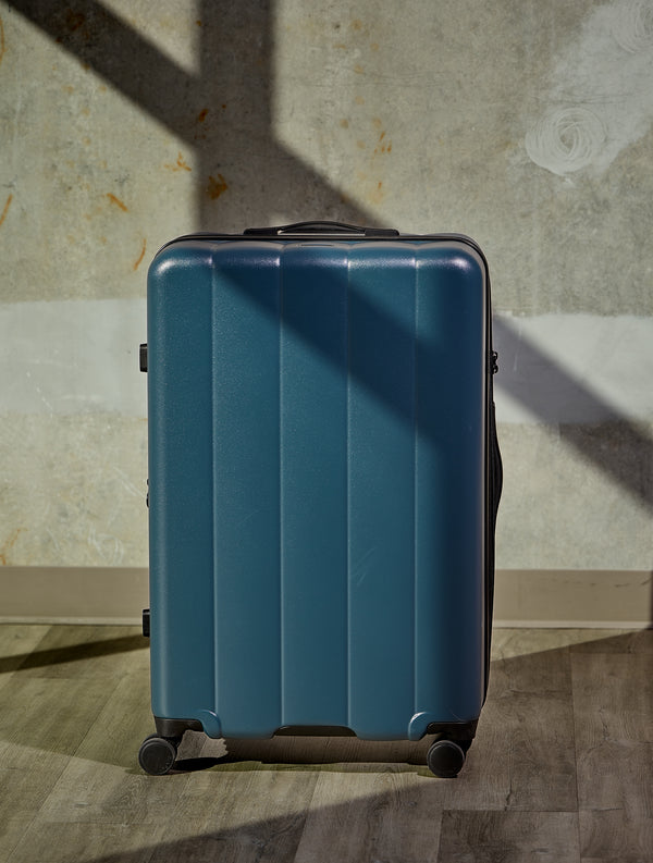 CALPAK Evry Large Luggage with dual-spinner wheels in pacific blue