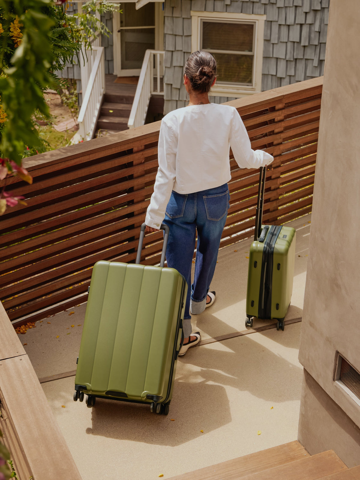 Model rolling CALPAK Evry Large Luggage and CALPAK Evry Carry-On Luggage in pistachio; LCO1028-PISTACHIO