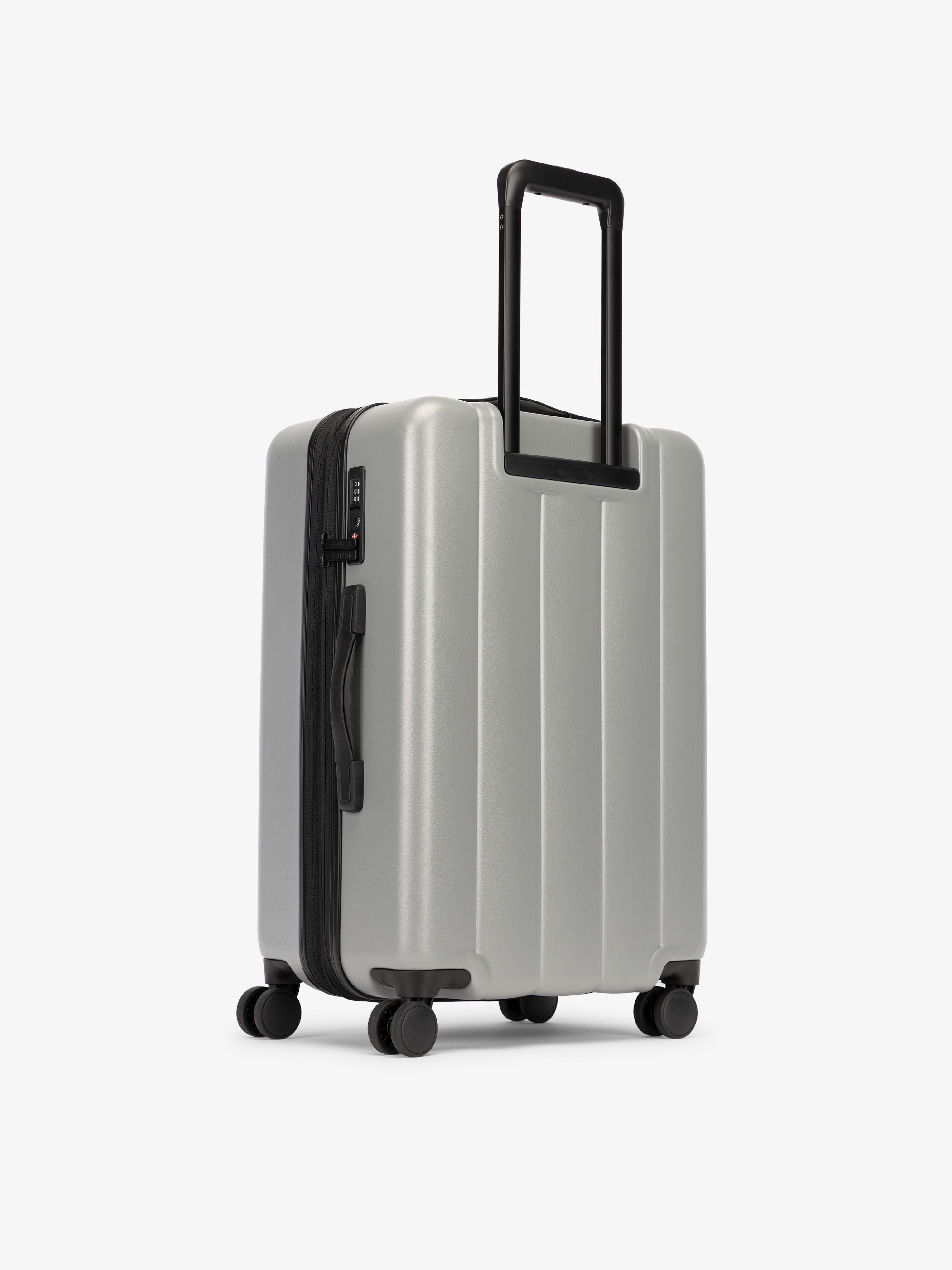 CALPAK medium luggage featuring dual spinner wheels and bottom grab handle in gray