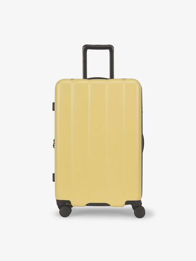 CALPAK Butter medium luggage made from an ultra-durable polycarbonate shell and expandable by up to 2