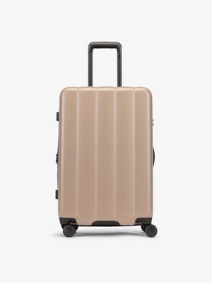 Brown chocolate medium luggage made from an ultra-durable polycarbonate shell and expandable by up to 2"; LCO1024-CHOCOLATE