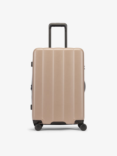 Brown chocolate medium luggage made from an ultra-durable polycarbonate shell and expandable by up to 2