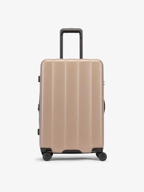 CALPAK Brown chocolate medium luggage made from an ultra-durable polycarbonate shell and expandable by up to 2"