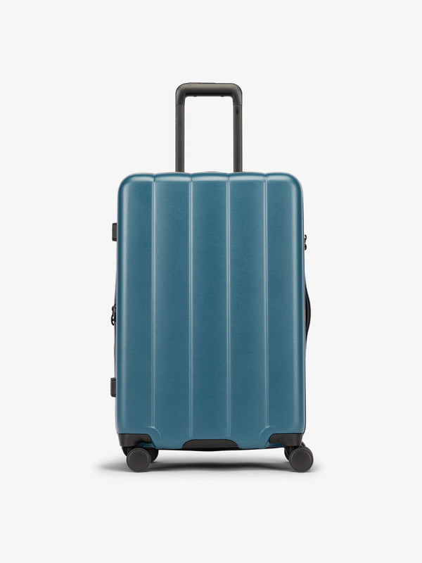 Pacific blue medium luggage made from an ultra-durable polycarbonate shell and expandable by up to 2"