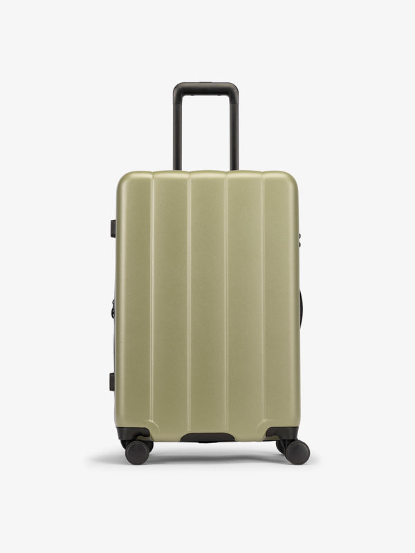 Green pistachio medium luggage made from an ultra-durable polycarbonate shell and expandable by up to 2"