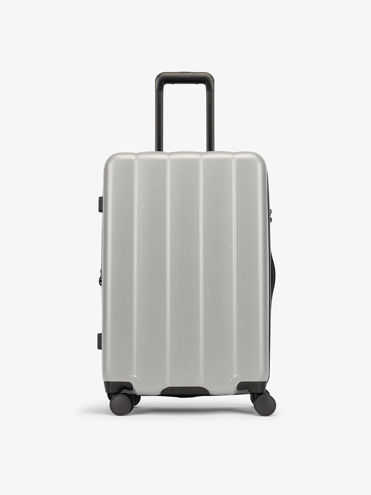 Smoke gray medium luggage made from an ultra-durable polycarbonate shell and expandable by up to 2"