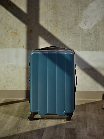 CALPAK Pacific blue large luggage made from an ultra-durable polycarbonate shell and expandable by up to 2