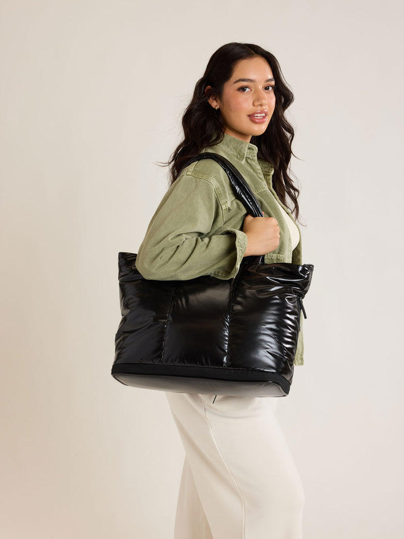 Model with CALPAK Luka Expandable Tote in Glazed Black
