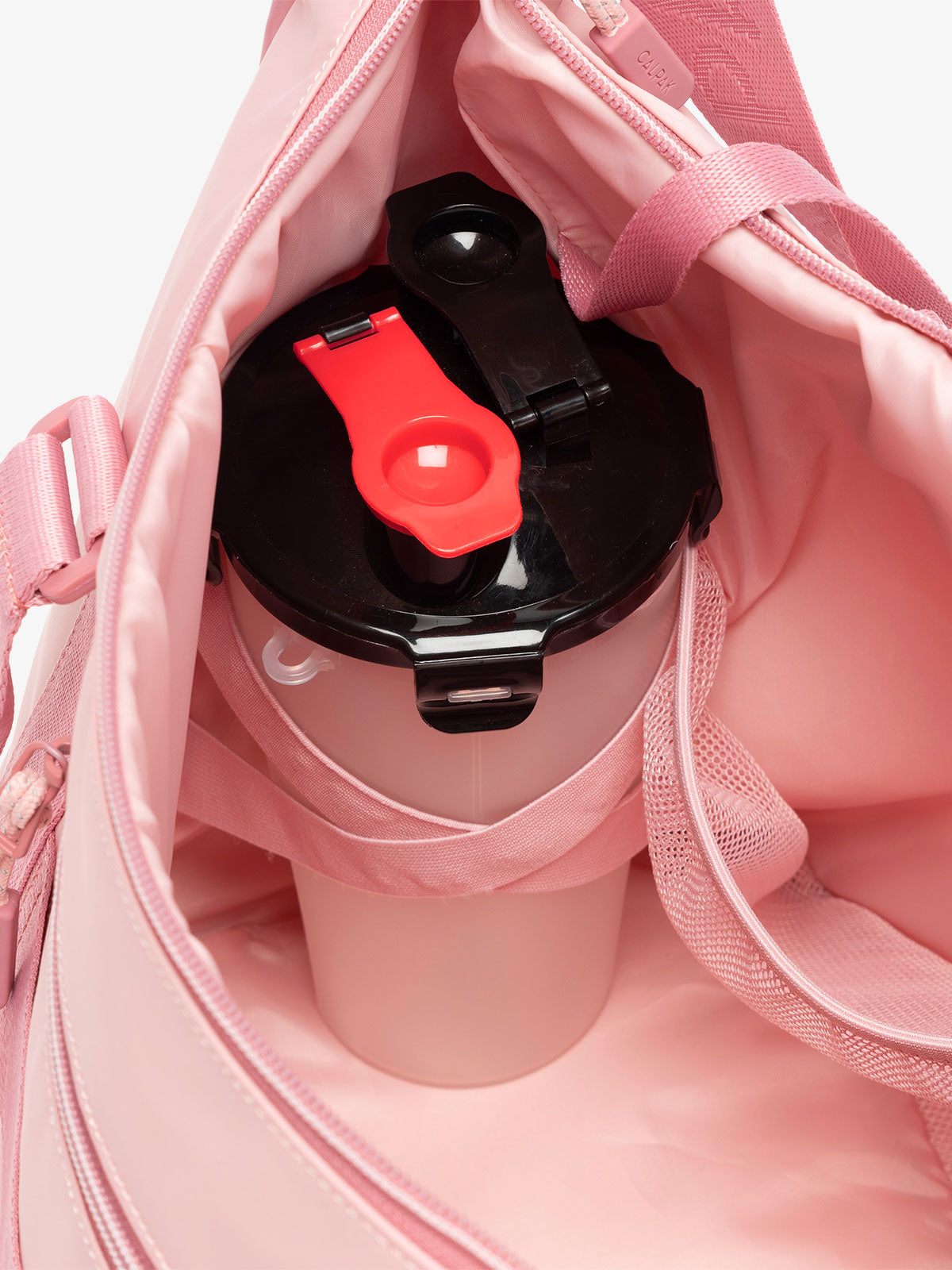 CALPAK Fit gym sling bag with interior "X" elastic to secure large water bottles in tea rose pink; TBF2401-TEA-ROSE, TBF2401-TEA-ROSE-GRIN, BTBF2401-TEA-ROSE