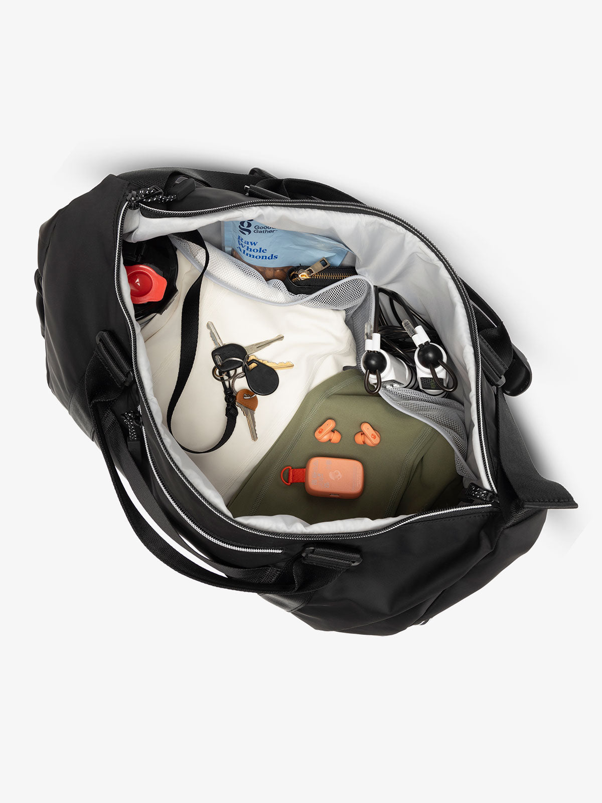 Interior view of black CALPAK Fit Gym Bag with personal belongings packed within; TBF2401-BLACK, TBF2401-BLACK-GRIN, BTBF2401-BLACK