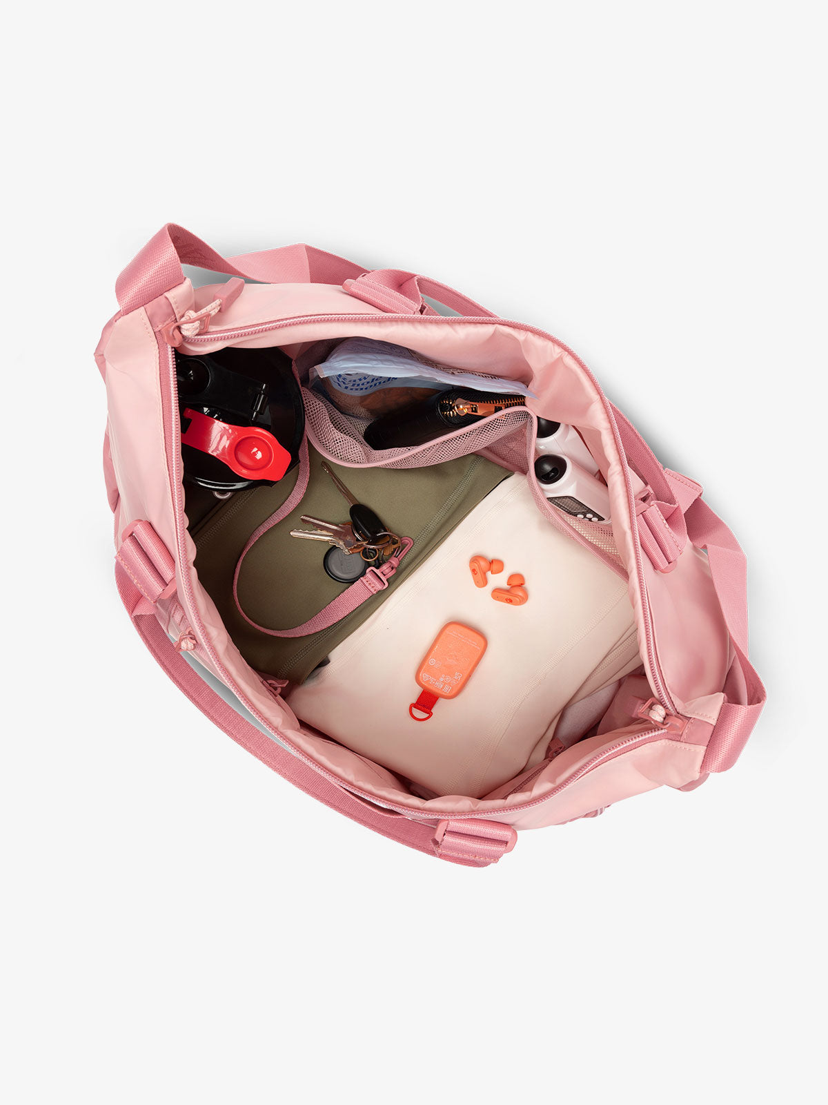 Interior view of tea rose pink CALPAK Fit Gym Bag with personal belongings packed within; TBF2401-TEA-ROSE, TBF2401-TEA-ROSE-GRIN, BTBF2401-TEA-ROSE