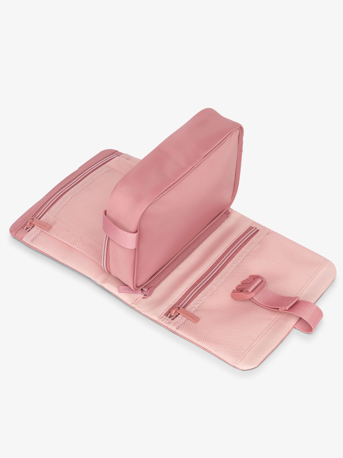 Flat lay of CALPAK Fit gym dopp kit with multiple interior mesh pockets in tea rose; TFH2401-TEA-ROSE, TFH2401-TEA-ROSE-GRIN, BTBF2401-TEA-ROSE