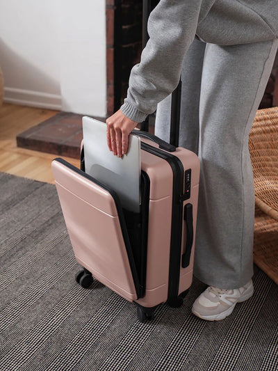 pink CALPAK Hue hard shell carry-on spinner luggage with laptop compartment; LHU1020-PINK-SAND