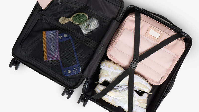 CALPAK Hue Carry On Luggage interior opened showing packed items