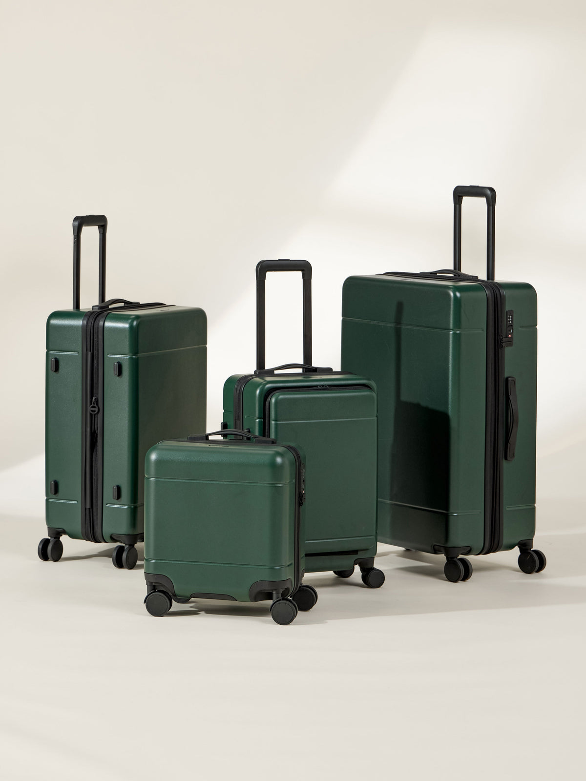 CALPAK Hue Full Luggage Set including Front Pocket Carry On, Mini Carry On, Carry On, and Large Luggage in forest green Emerald; LHU1014-EMERALD