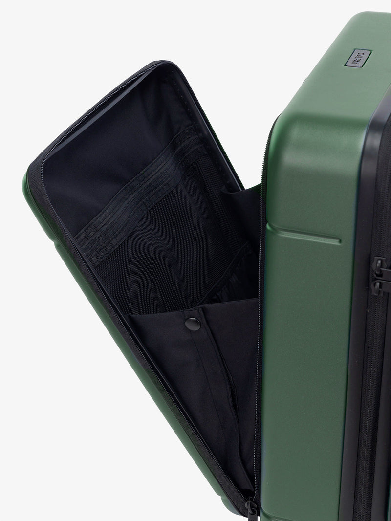 CALPAK Hue Front Pocket Carry-On Luggage front pocket open view with telescopic handle in green Emerald