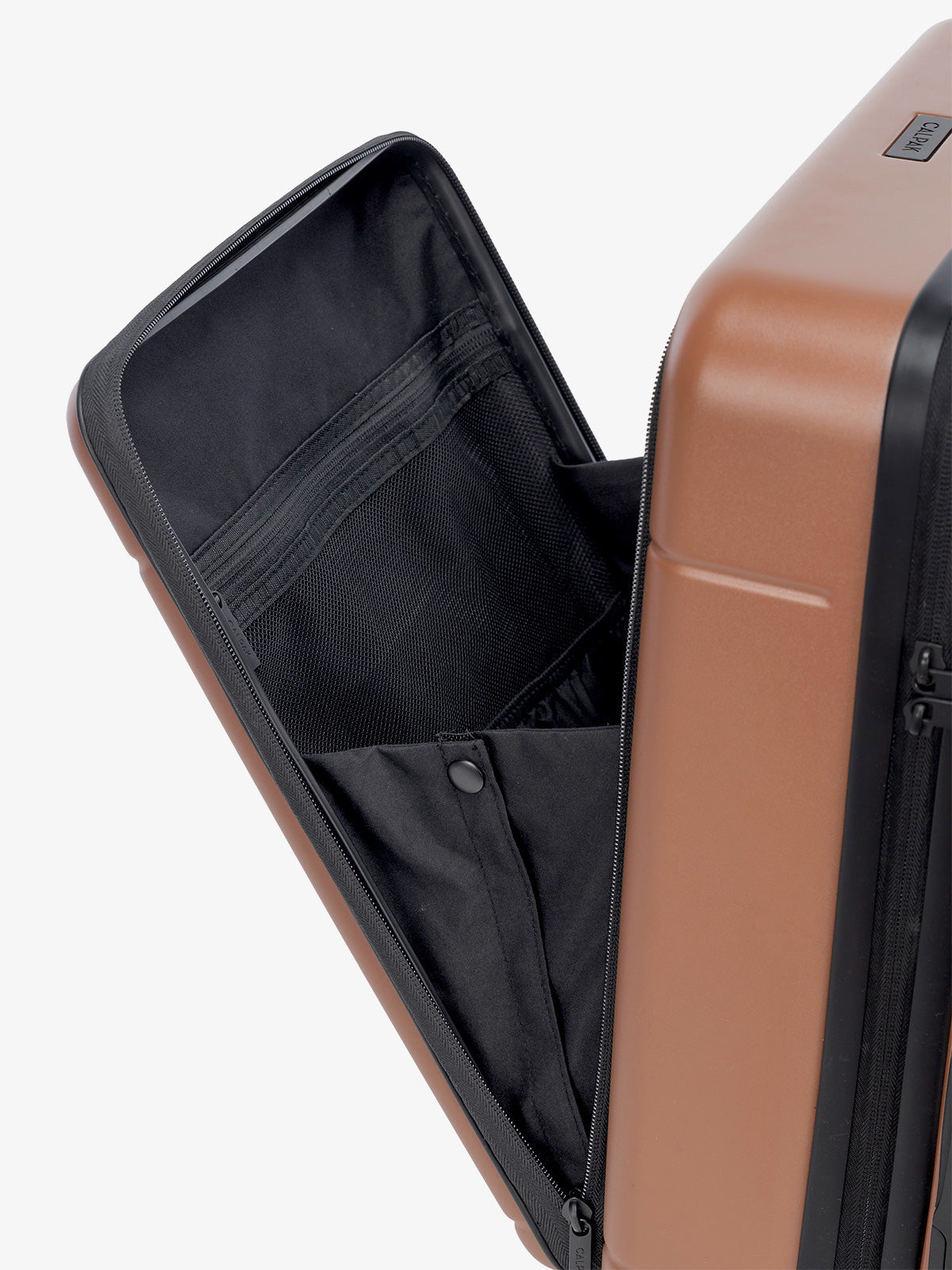 the laptop compartment of CALPAK Hue carry-on suitcase in brown hazel color; LHU1020-HAZEL