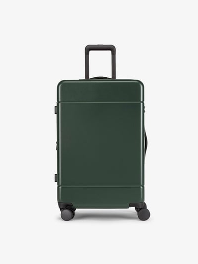 CALPAK Hue Medium 26 inch hardside Luggage front view in green Emerald; LHU1024-EMERALD