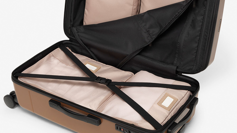 CALPAK Hue Medium Trunk Luggage opened showing items packed inside