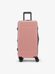 CALPAK Hue Medium Trunk Luggage with durable hard-shell exterior, cushioned top handle and 360 spinner wheels in mauve; LHU1026-MAUVE