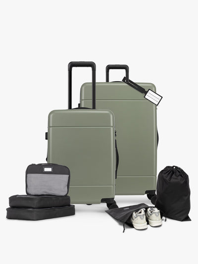 CALPAK Hue Starter Bundle in green Juniper that comes with Large and Carry On Luggage, Luggage Tag, Two Black Pouches, and Three Black Packing Cubes shown on a white background; LHU8000-JUNIPER view 1
