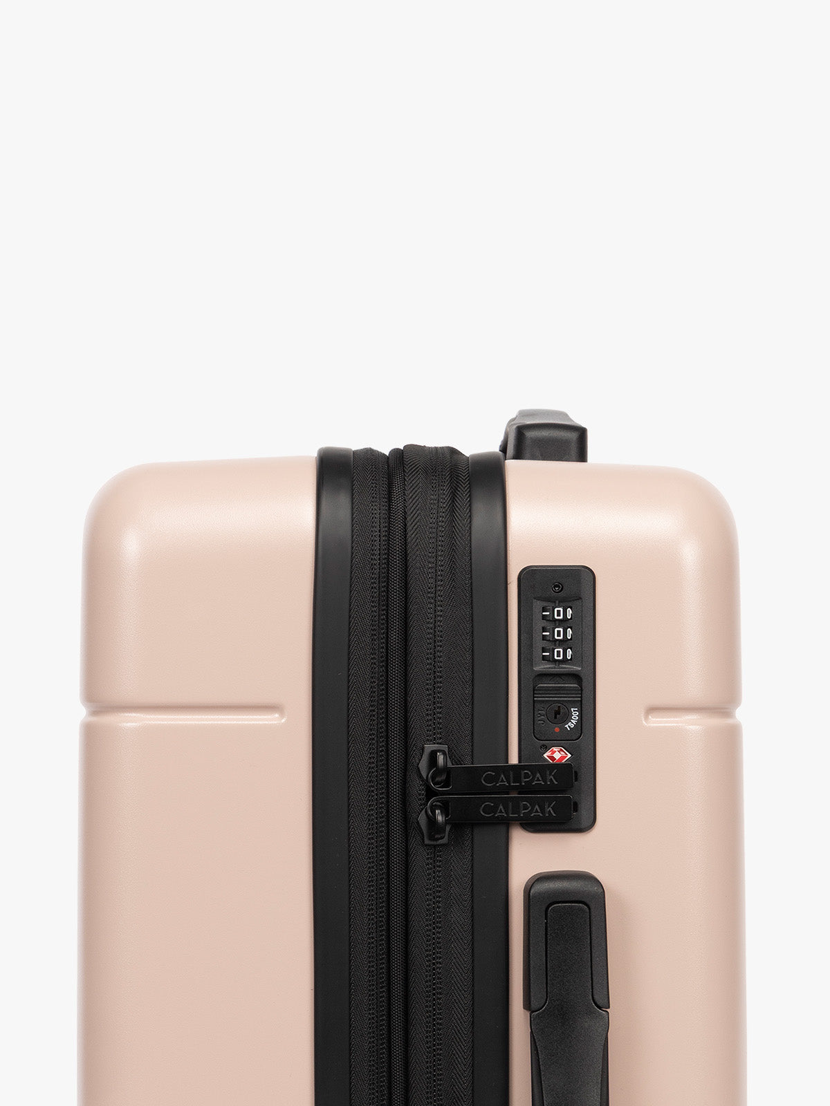 TSA-approved lock on the CALPAK Hue Starter Bundle in light pink Rose Quartz that comes with Large and Carry On Luggage with op handle on a white background; LHU8000-ROSE-QUARTZ