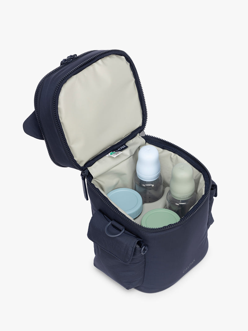 Opened and baby bottles in CALPAK Insulated Baby Bottle Bag in blue navy