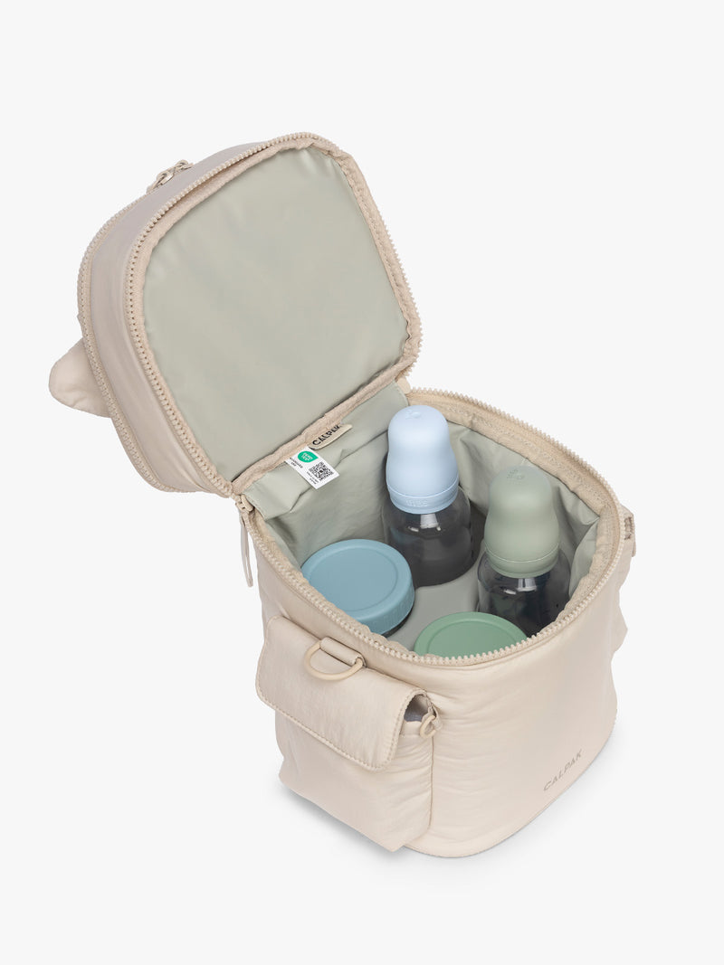Opened bottom compartment with baby bottles in the CALPAK Insulated Baby Bottle Bag in beige Oatmeal
