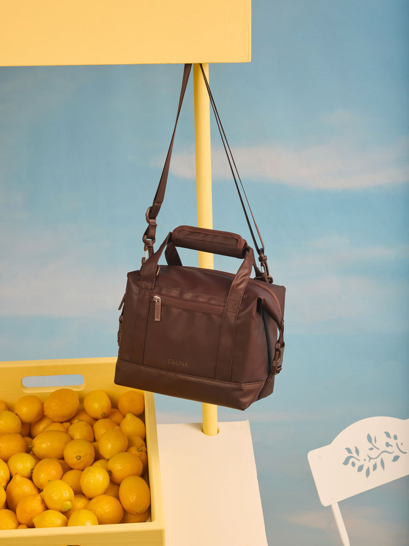CALPAK Insulated 8L Soft-Sided Cooler in brown Walnut hanging on lemonade stand