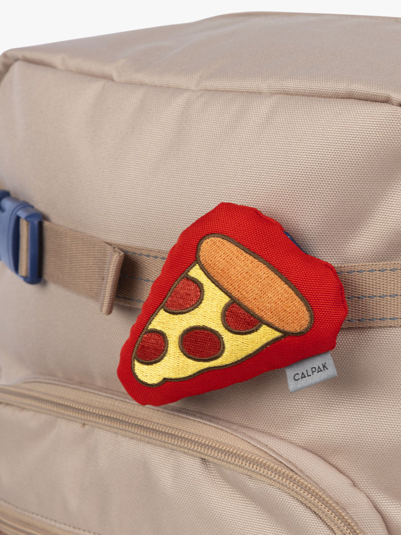 CALPAK Kids Collection red and yellow pepperoni Pizza Pluffy Bag Charm attached to Kids Large brown and tan Khaki Backpack
