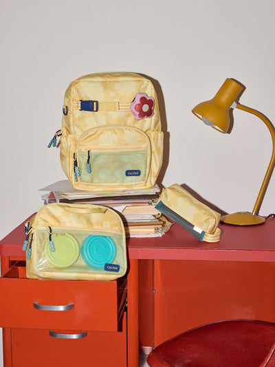 CALPAK Kids Small Backpack in yellow with tan flower print in Yellow Bloom for ages 3-5 is built for your little one’s big days with yellow zippers and blue mesh front pocket, multiple interior pockets for an 11” tablet or laptop, and padded comfort straps; CKBS2501-YELLOW-BLOOM view 2