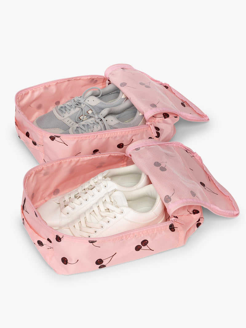 Opened CALPAK Shoe Cubes pink with cherry print with shoes inside