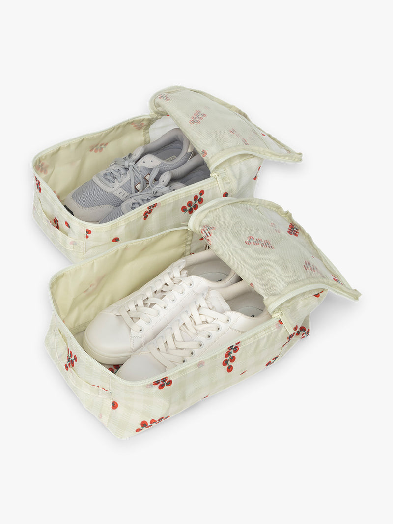 Shoes inside CALPAK Shoe Bag in white and green gingham pattern with tomato print