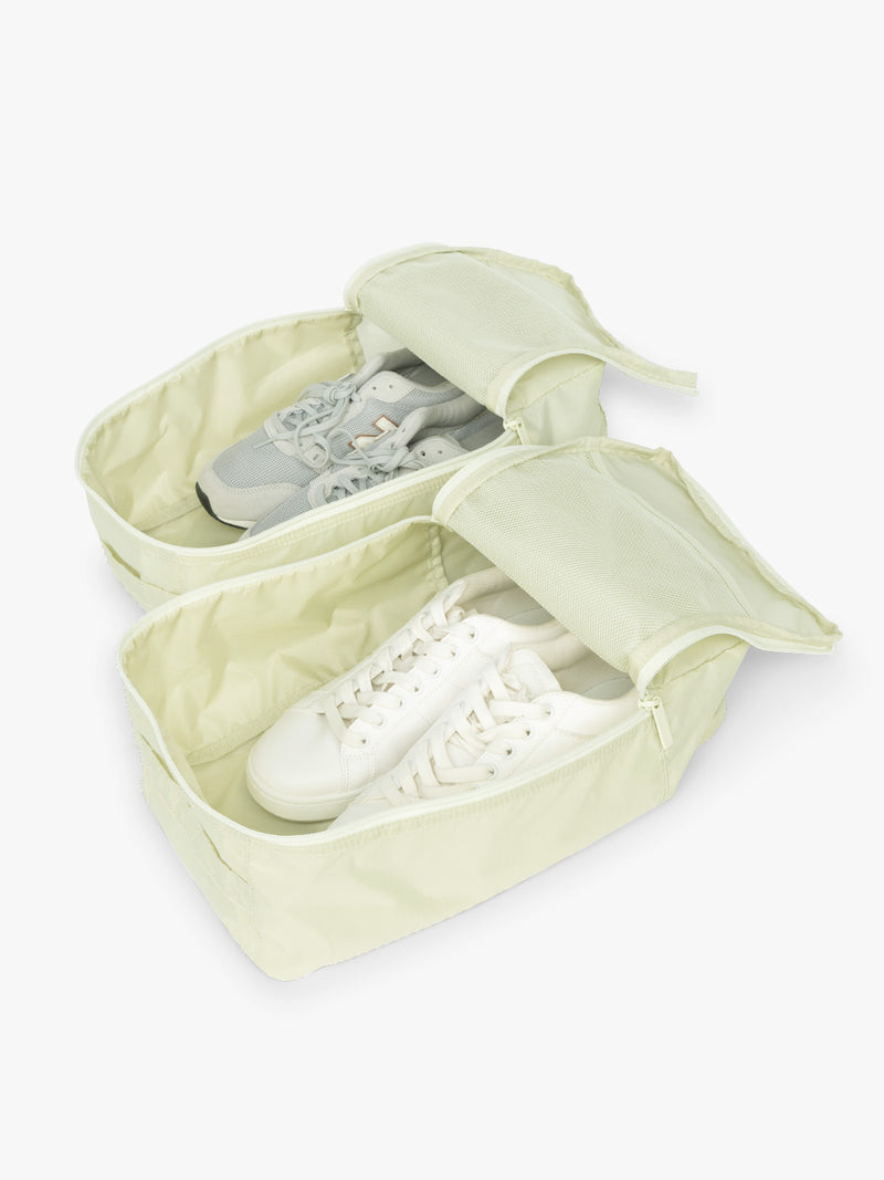 Two set of shoes in the CALPAK Shoe Bag in light green Celadon