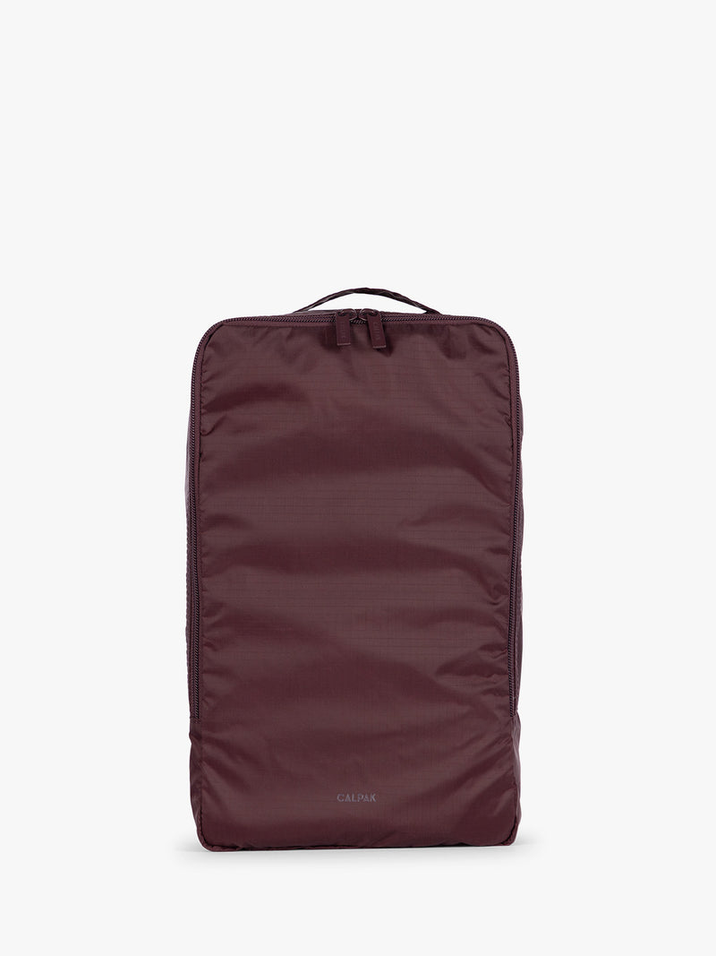 Burgundy Dark Cherry rectangular CALPAK shoe cube with zippers and top handle shown on a plain background