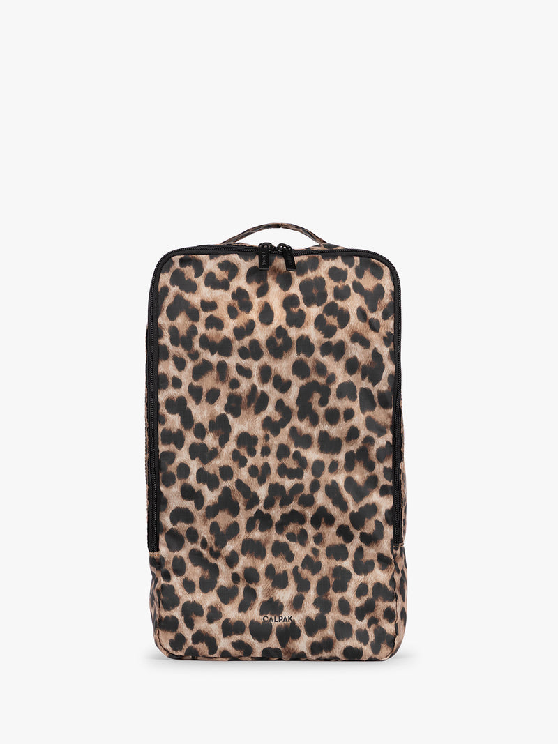 Tan and black animal print Leopard rectangular CALPAK shoe cube with zippers and top handle shown on a plain background